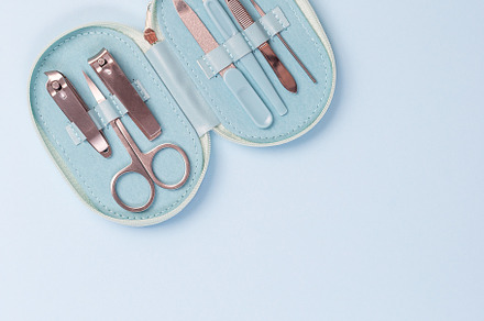Manicure or pedicure set equipment, on blue background, copy space, top view, s, a Beauty & Fashion Photo by iuliia_n