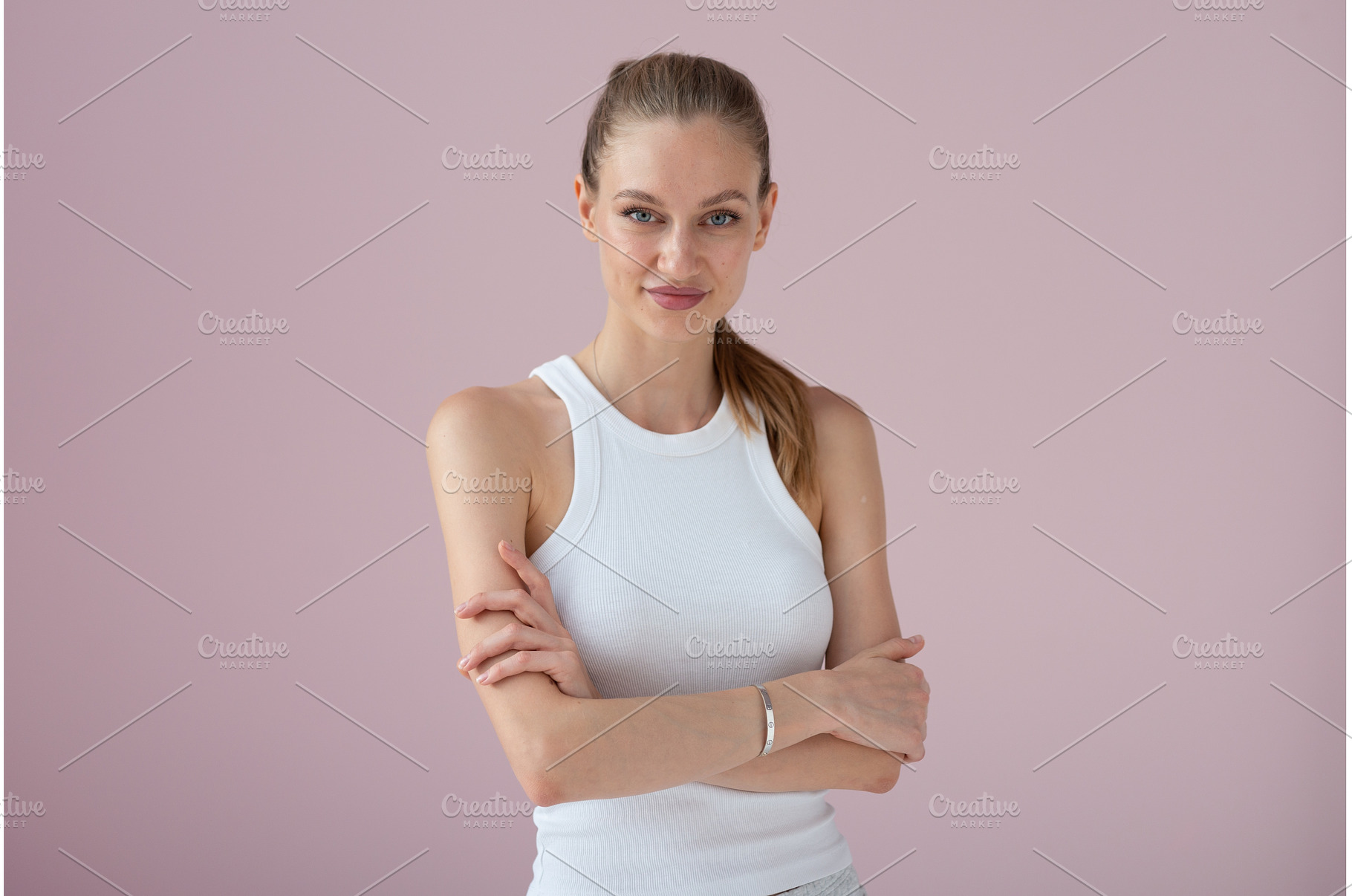 Woman in white athletic tank on pink, a Person Photo by undrey