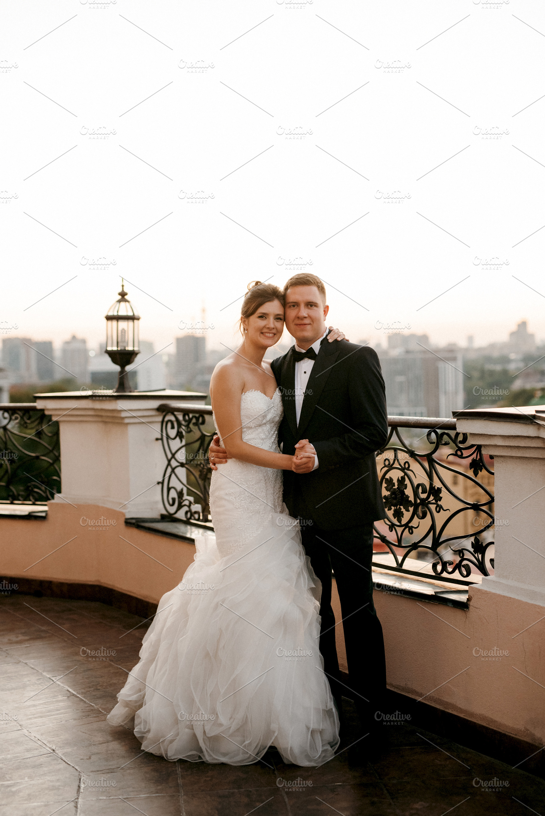 young couple bride and groom on the roof of a tall building agai, a Person Photo by Weddings, People, Travel