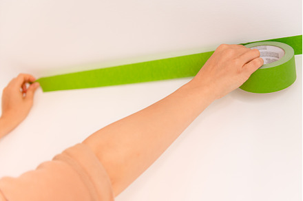Applaying masking tape to the wall, an Architecture Photo by MAnuta