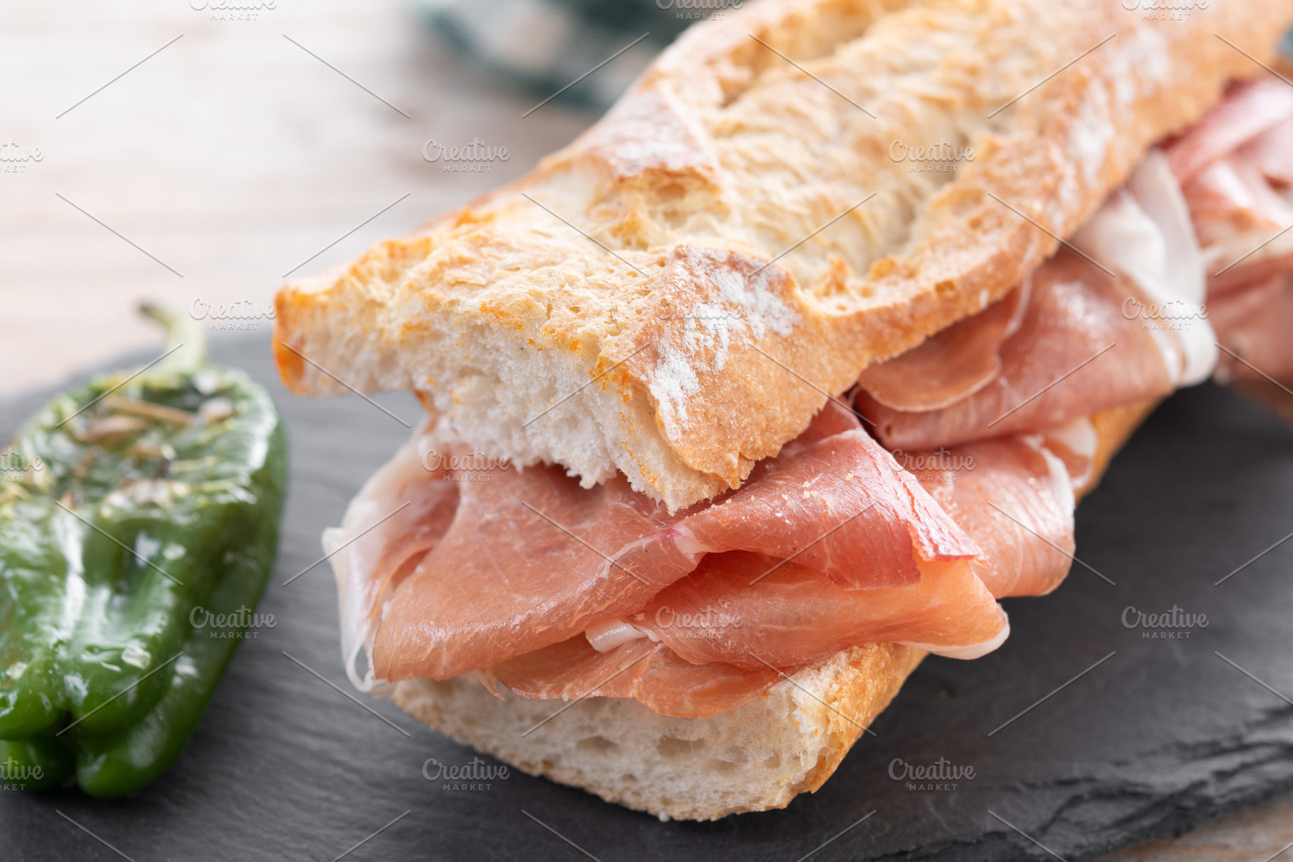 Spanish serrano ham sandwich on wooden table, a Food & Drink Photo by etorres69
