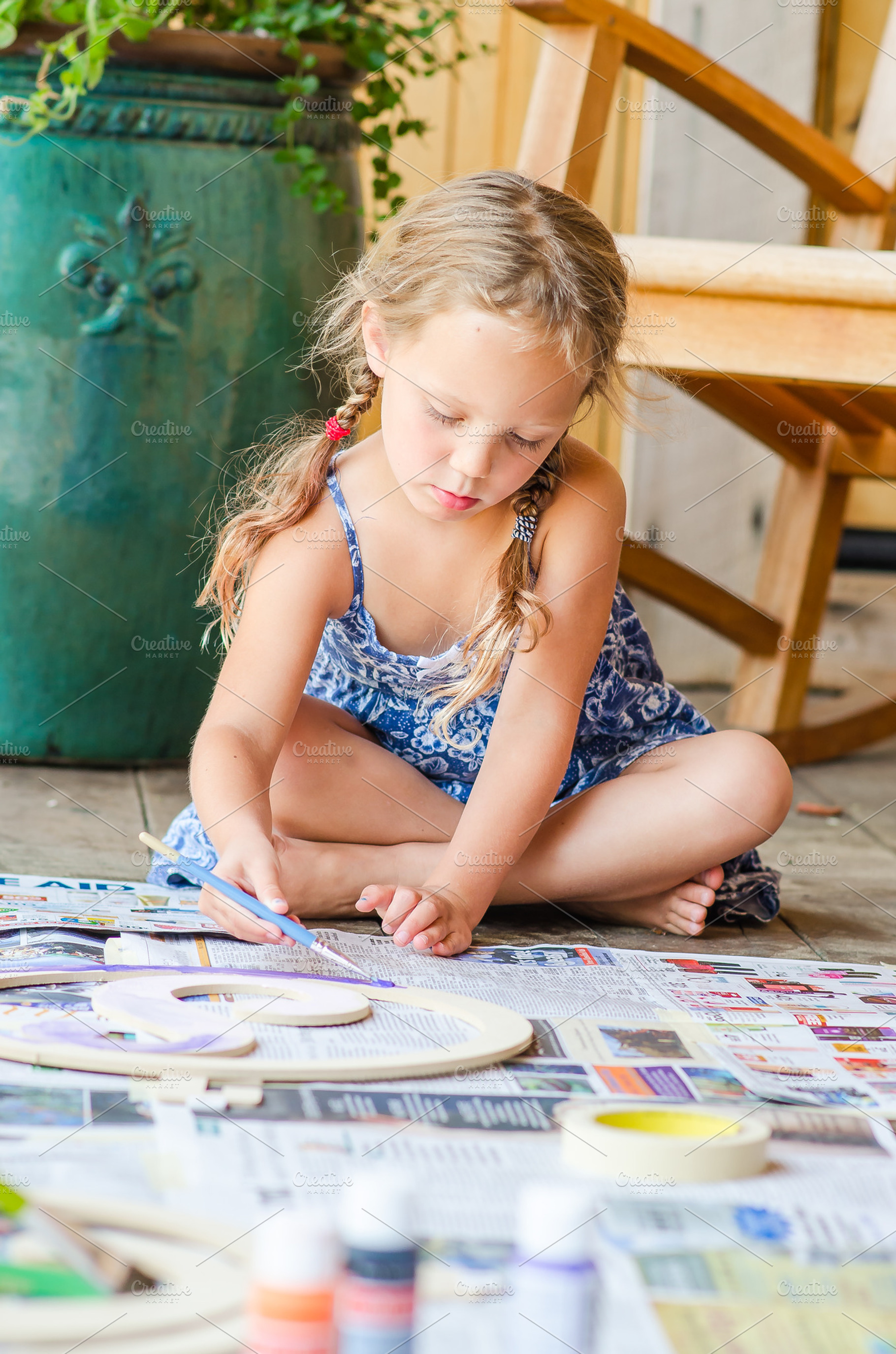 Girl doing an Art Project Outdoor, a Person Photo by Frizz Studio