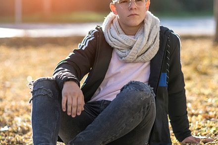 Young happy boy teenager sitting on floor in front of the camera in posed portr, a Person Photo by 2Design