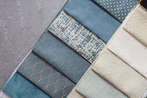 Fabric samples on the table the des containing curtains, blue, and modern