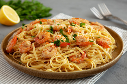Baked Shrimp Scampi Linguine Pasta with Parsley on a Plate, side, a Food & Drink Photo by LiudmylaChuhunova
