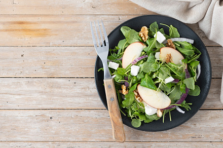 Autumn salad with apples and walnuts on wooden table, a Food & Drink Photo by etorres69
