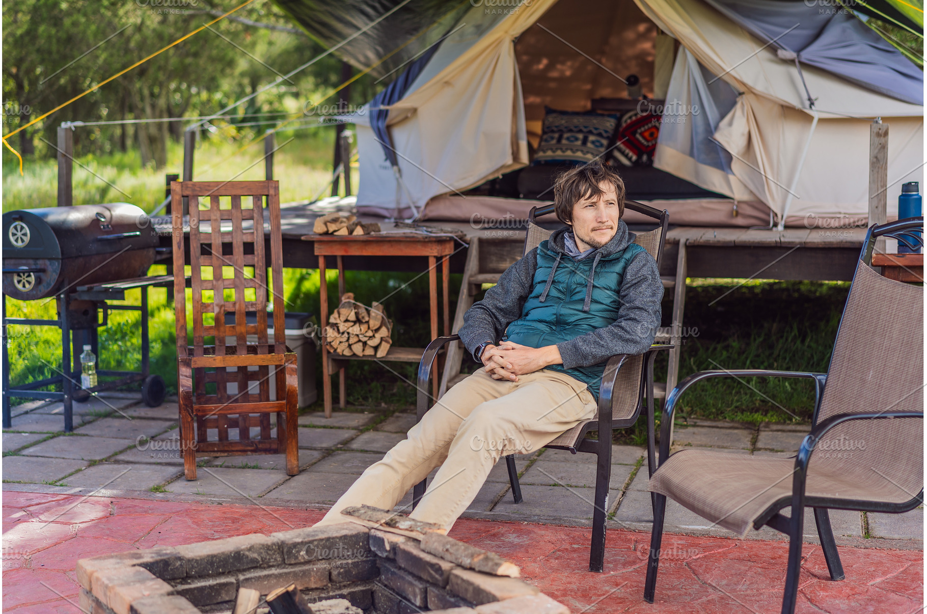 Man sitting by a campfire in front, a Person Photo by Elizaveta Galitskaya