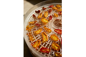 Drying colorful cherry tomatoes in a, a Food & Drink Photo by IlliaBondarPhotography