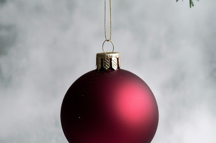 Red Christmas ornament hanging from Christmas tree branch, suita, a Photo by Dvoevnore photos