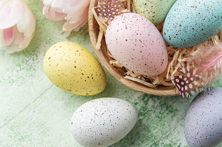 Bowl with Easter eggs painted pastel colors on a green wooden ba, a Holiday Photo by Olena Rudo