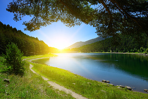 Beautiful sunrise over blue lake and mountains, a Nature Photo by Serg64