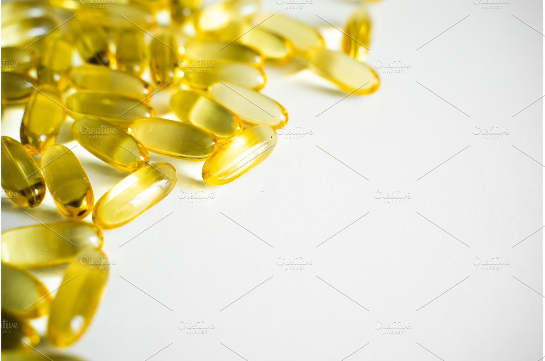Fish oil omega-3 capsules on white, a Health & Medical Photo by volodymyrshtun13795