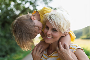 A portrait of mother carrying little, a Person Photo by HalfPoint