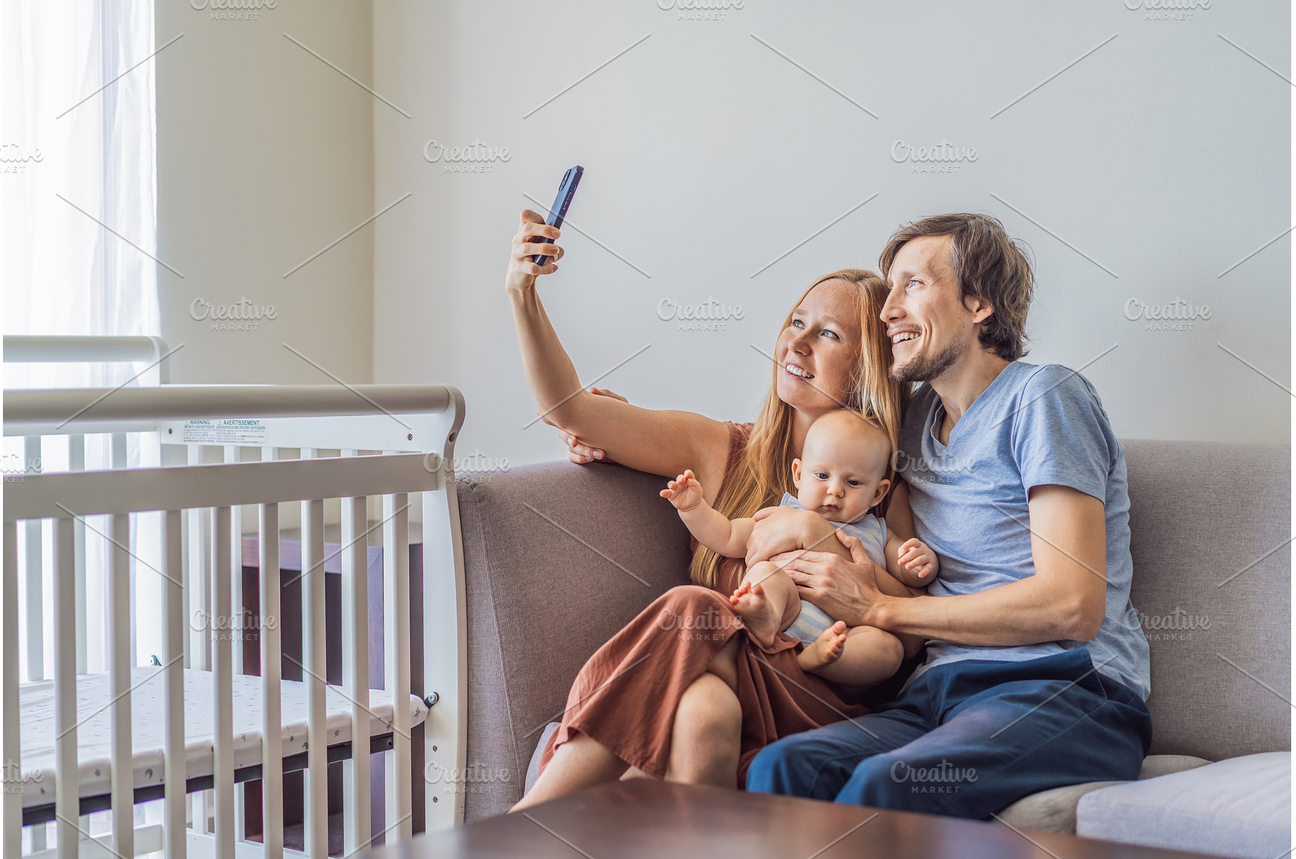 Mother and father sitting on sofa, a Person Photo by Elizaveta Galitskaya