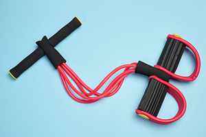Red and black fitness expander, four elastic tubes, soft handles, a Sports & Recreation Photo by ndanko