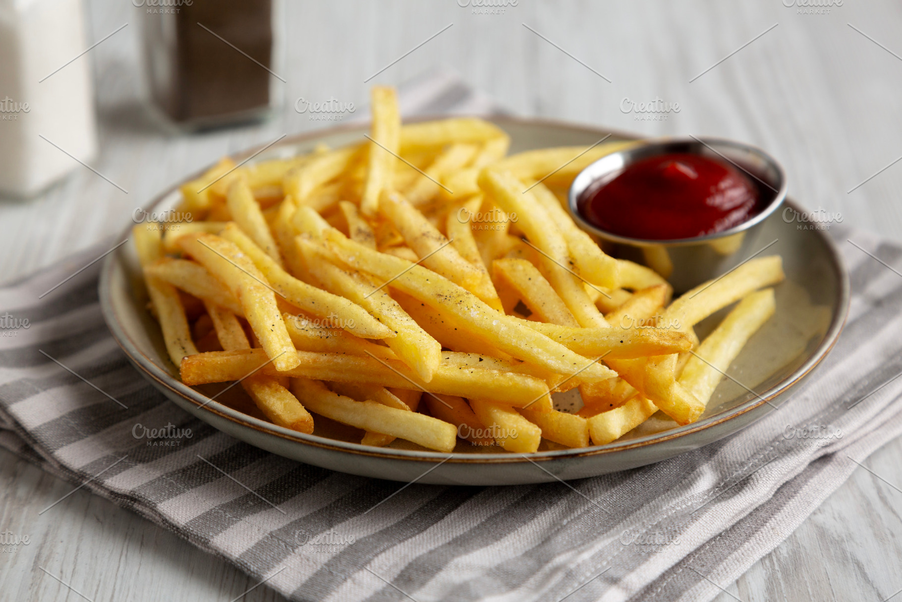Homemade French Fries and Ketchup on a Plate, side view. Close-u, a Food & Drink Photo by LiudmylaChuhunova