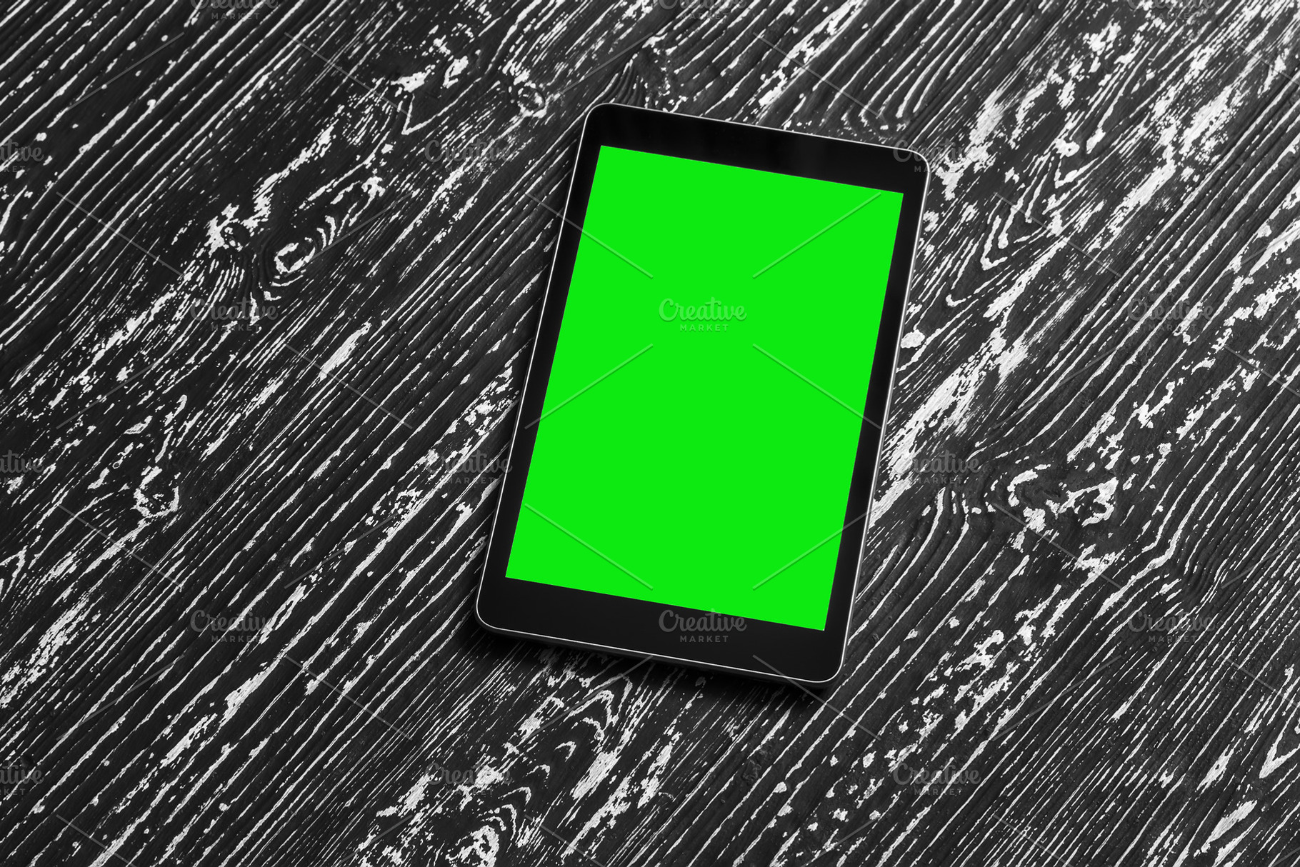 Black tablet with green screen on a wooden table mock up. Copy s, an Abstract Photo by Eugene_Photo
