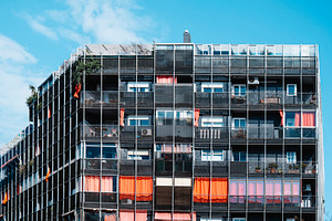 top section of a contemporary apartment block, a Photo by Nito