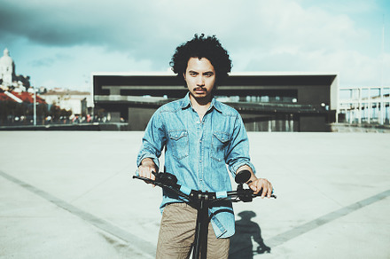 Man with scooter in urban setting, a Person Photo by SkyNext