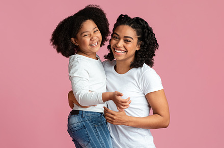 Laughing black mother and daughter c, a Background Photo by Prostock-Studio