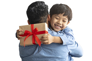 Father hugging his child after receiving a handmade fathers day, a Person Photo by DanFLCreativo