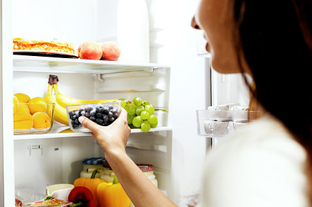 Woman hand taking or picks up box of blueberry out of open refrigerator, fridge, a Food & Drink Photo by Lenor4ik