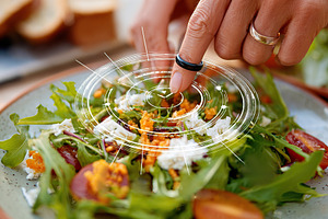 Exploring augmented reality features on a fresh salad during a sunny outdoor me, a Photo by AlyaAnd