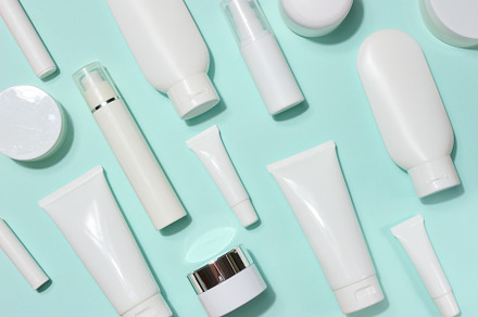 A variety of white plastic tubes and bottles with cosmetics, ran
