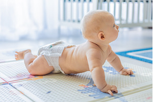 Baby lying on play mat learning to, a School & Education Photo by Elizaveta Galitskaya