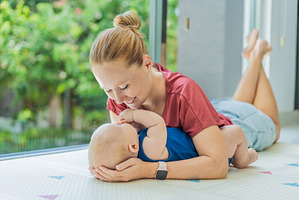 Mother and baby lying on a soft play, a Person Photo by Elizaveta Galitskaya
