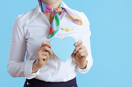 Closeup on elegant air hostess woman on blue, a Business Photo by Alliance Images