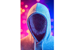 Anonymous person in hood with, a Technology Photo by Lermont51