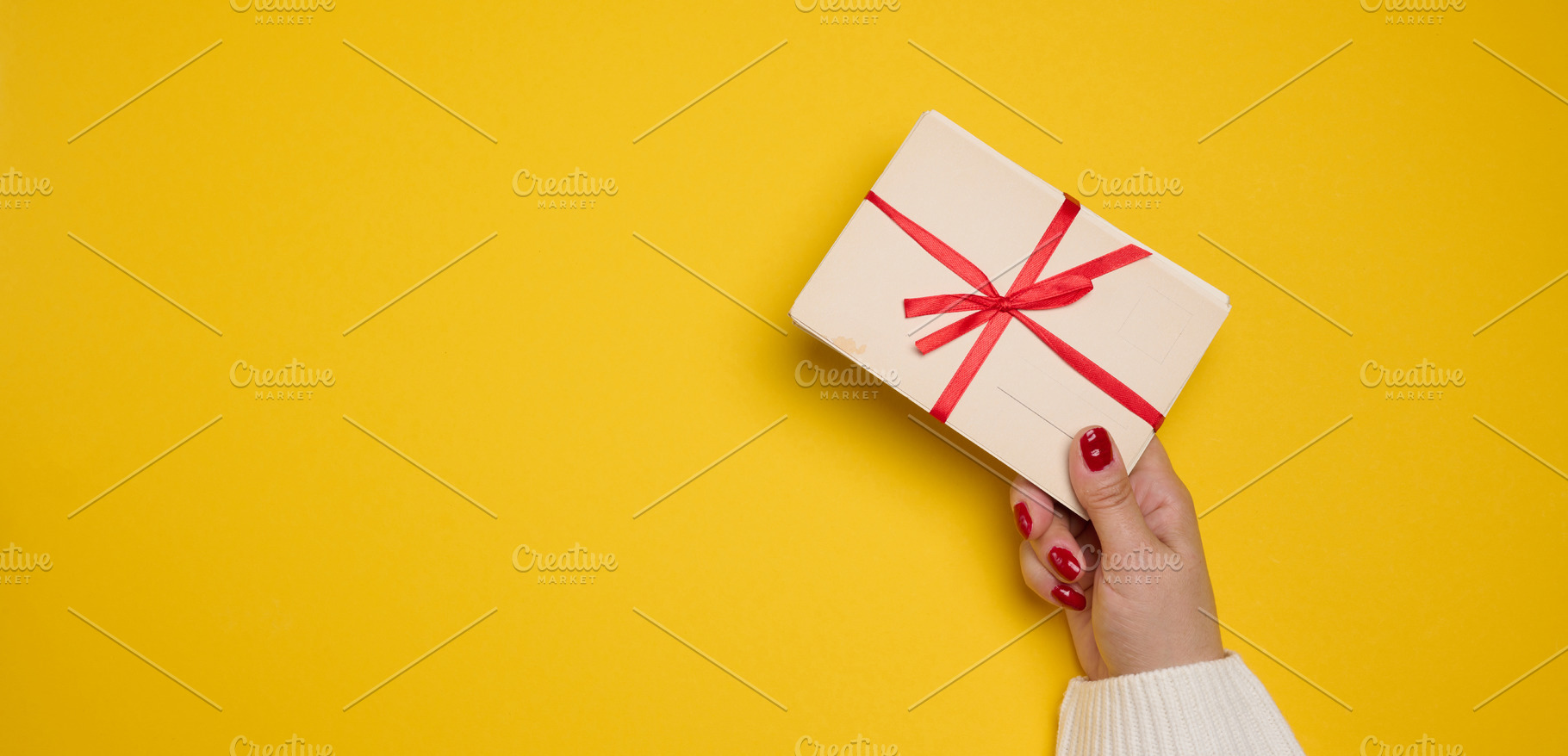 A woman's hand in a white sweater holds a stack of blank postcar, a Holiday Photo by ndanko