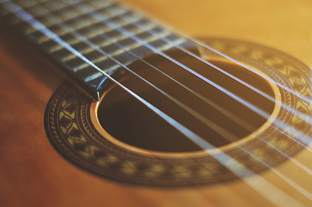 Guitar containing guitar, strings, and music