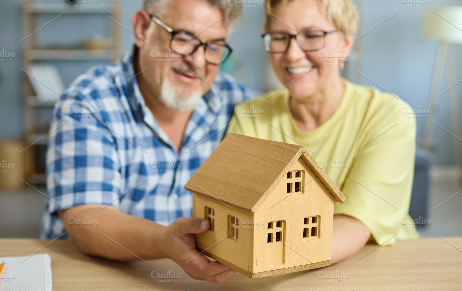 Senior Couple Holding House Model, a Person Photo by StudioRomantic