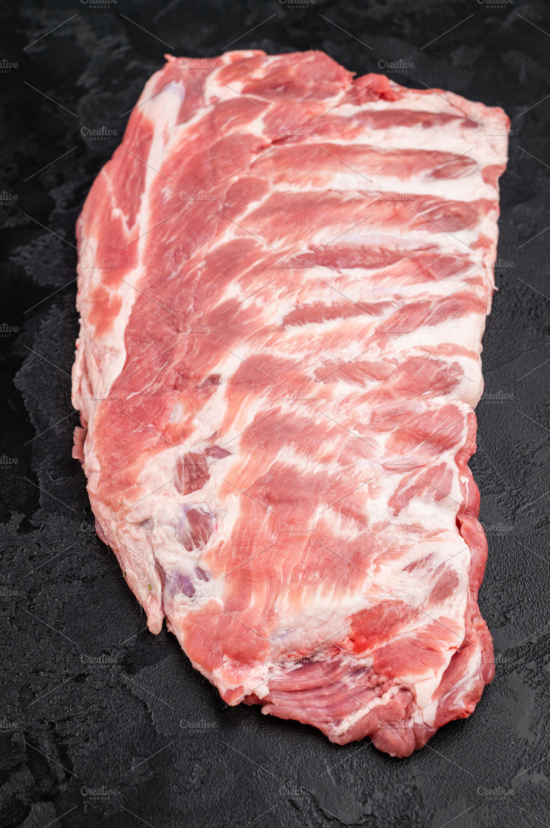 Raw pork spareribs slab with bone and butcher knife flat lay on, a Food & Drink Photo by composter-box@mail.ru
