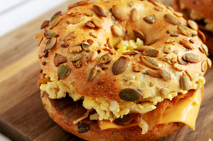 Homemade Bacon, Egg & Cheese Bagel Breakfast Sandwich on a woode, a Food & Drink Photo by LiudmylaChuhunova