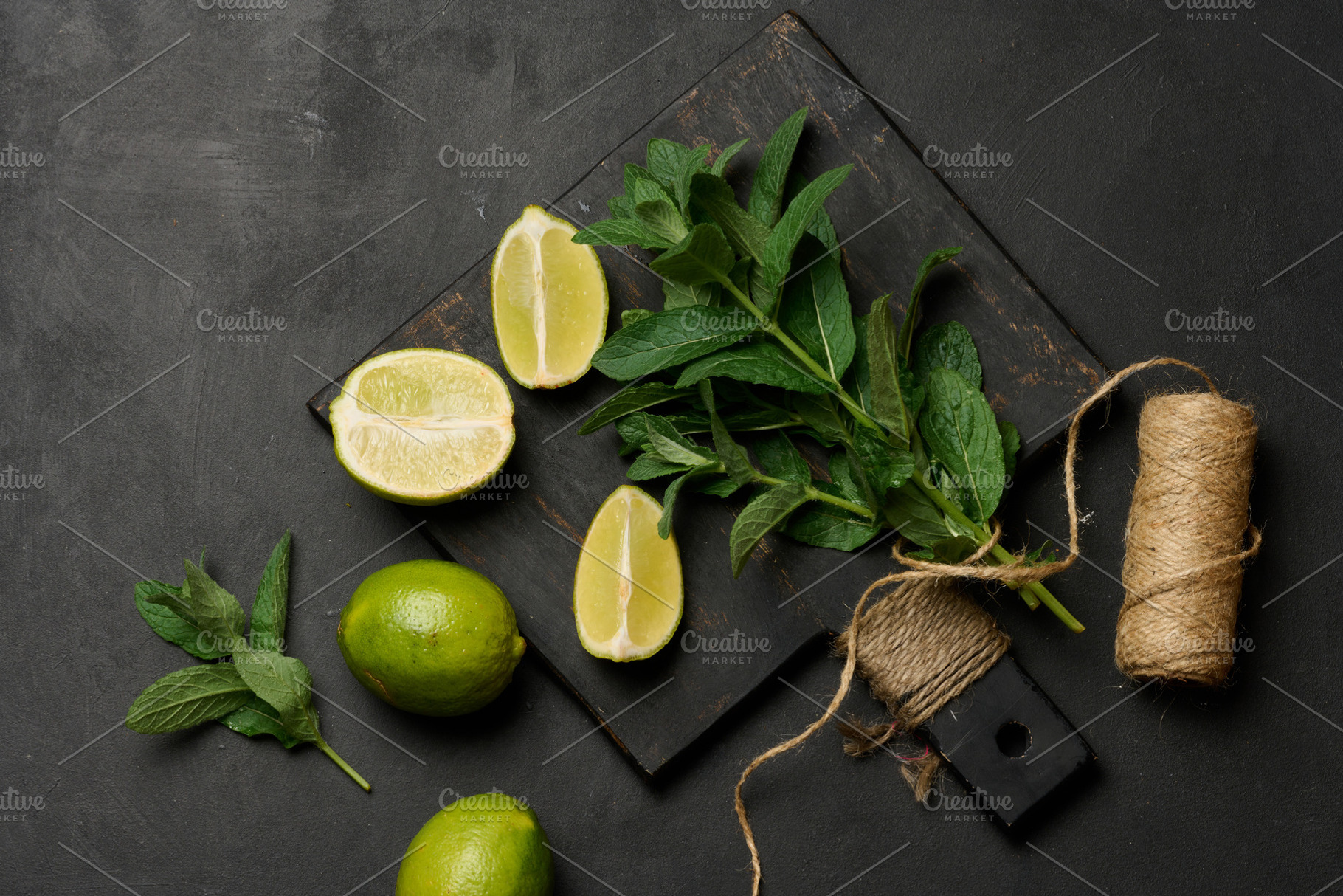Bunch of fresh green mint and lime wedges on wooden board, a Food & Drink Photo by ndanko