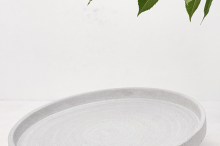 Gray empty decorative plate on white background, product and cos, an Abstract Photo by ndanko