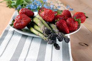 Fresh asparagus with strawberries containing asparagus, bunch, and crispy