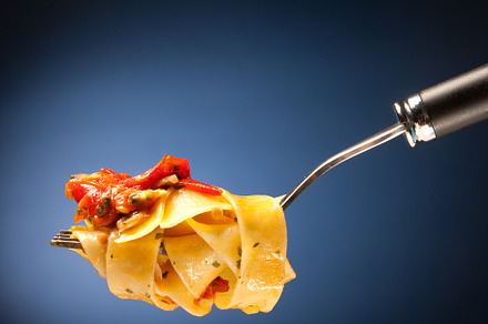 Tagliatelle with clams on a red background