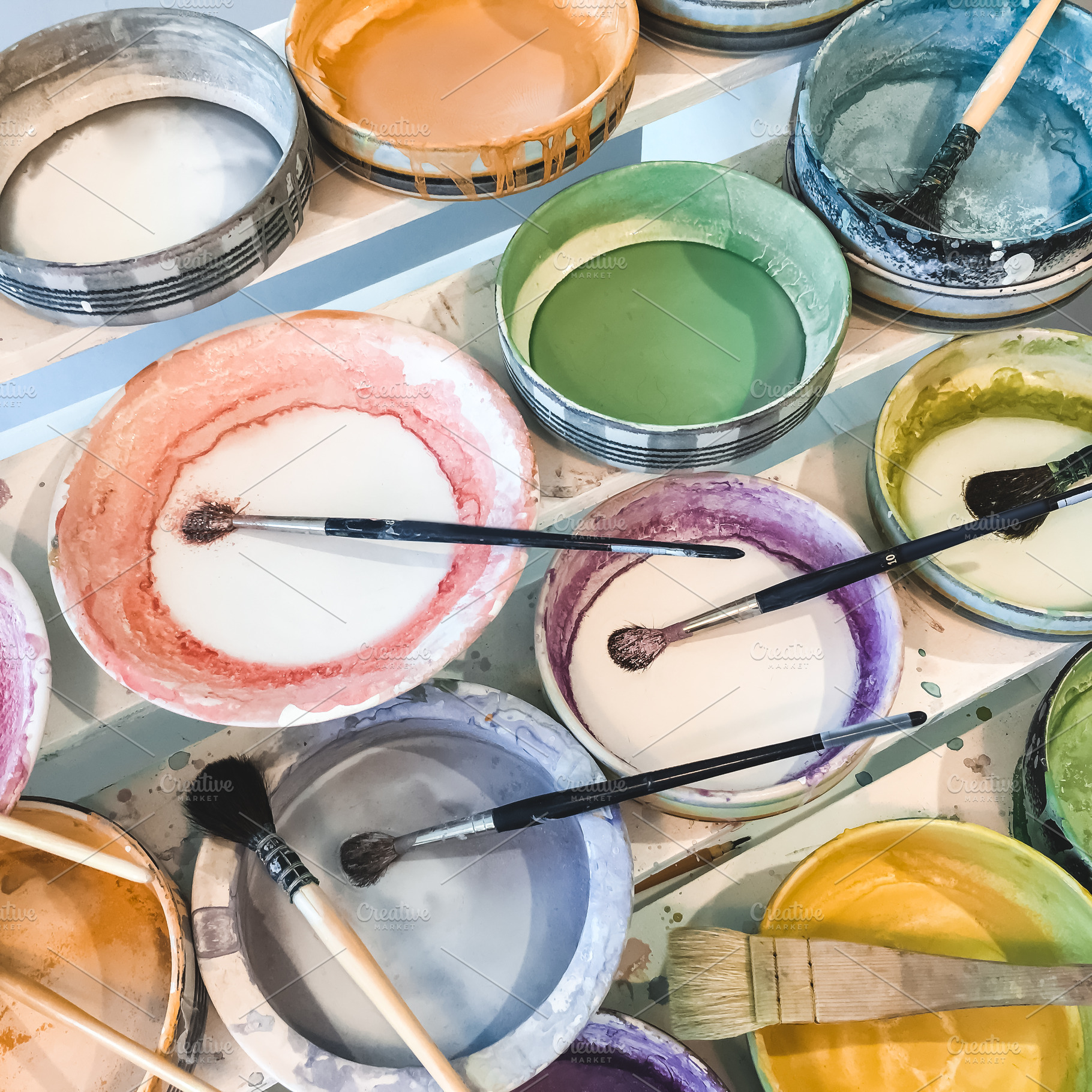 Paint brushes in colorful plates, an Arts & Entertainment Photo by Studio Light & Shade