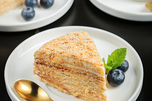 Medovik. Honey cake made from honey cakes with whipped sour crea, a Food & Drink Photo by Budarinphoto
