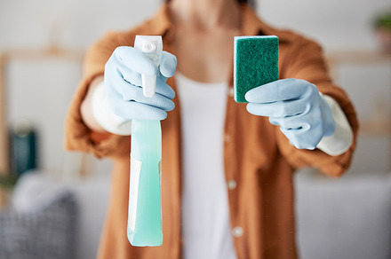 Cleaning service, product or hands with sponge for bacteria, dust or dirty surfaces on furniture in home. Zoom, safety or healthy cleaner with liquid soap chemical in spray bottle for spring cleaning, a Photo by Peopleimages.com