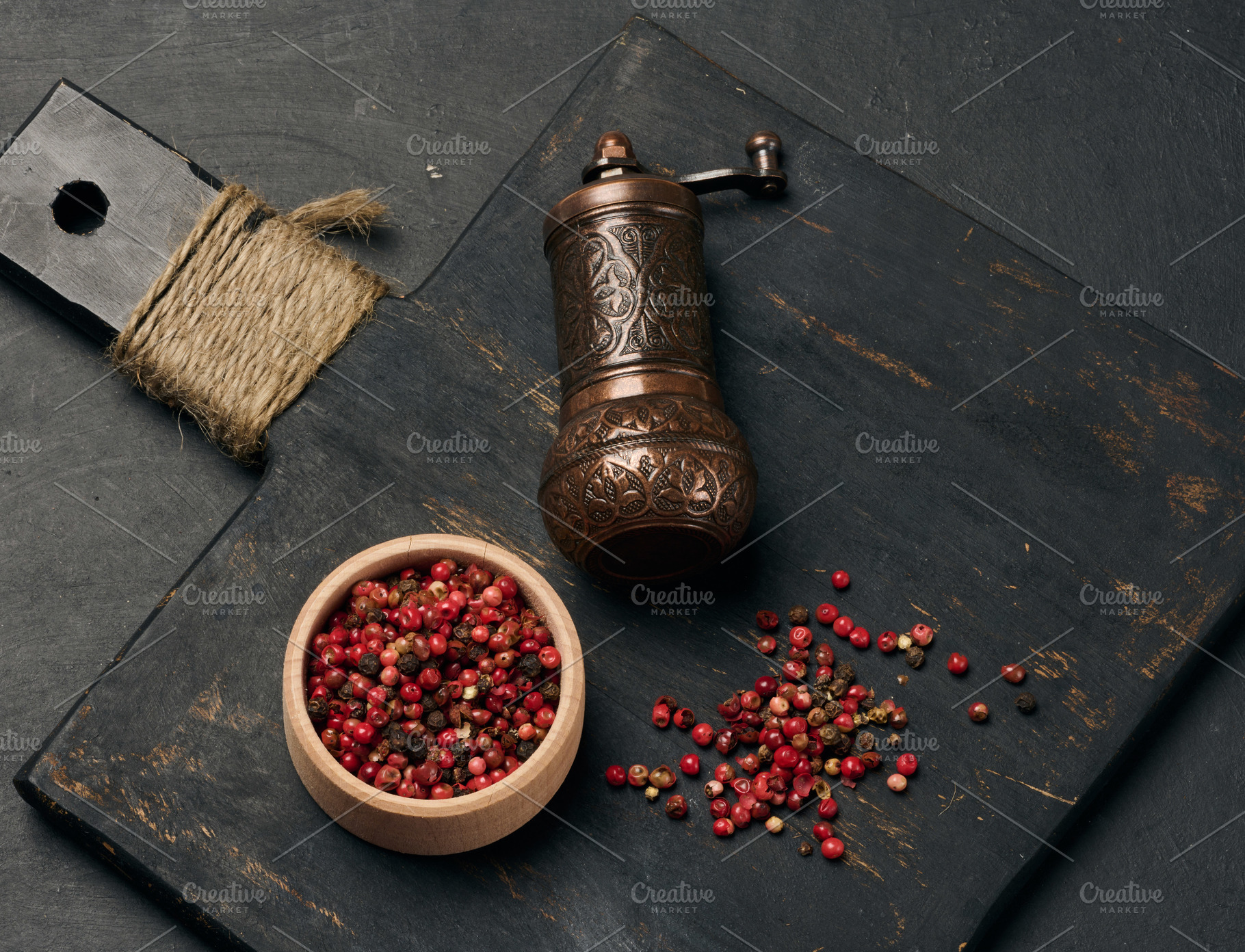 Antique copper pepper shaker and red dried peppercorns on a dark, a Food & Drink Photo by ndanko