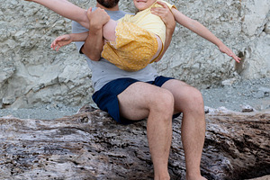 Smiling father and young daughter enjoying playful moment together, sitting on, a Person Photo by Ales Munt
