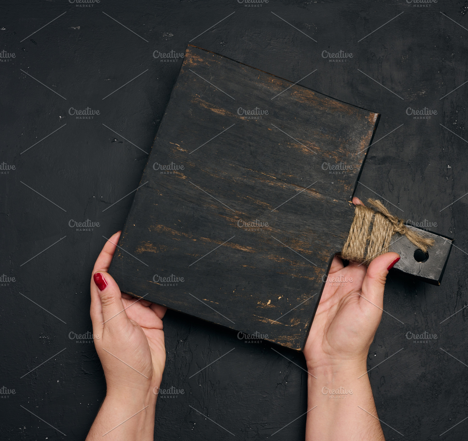 A woman's hand holds the handle of an old, black wooden kitchen, a Person Photo by ndanko