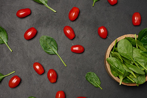 A wooden bowl filled with fresh spinach leaves surrounded by sca, a Food & Drink Photo by ndanko