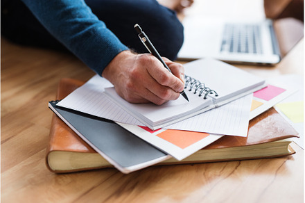 Close up of man writing notes in, a Business Photo by HalfPoint