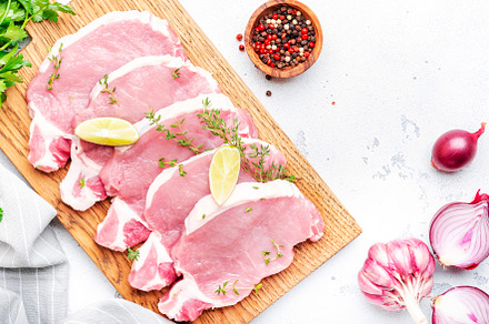 Raw pork chops, loin  on wooden cutting board prepared for cooki, a Food & Drink Photo by 5PH